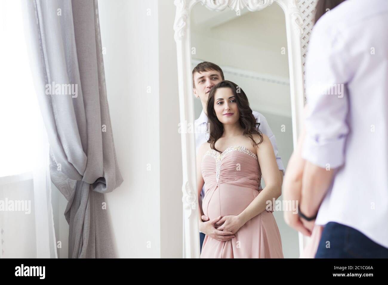 Portrait of the pregnant woman and young man together Stock Photo - Alamy