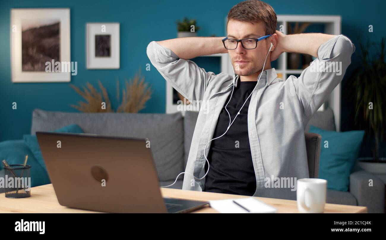 Relaxed man looking laptop screen Stock Photo