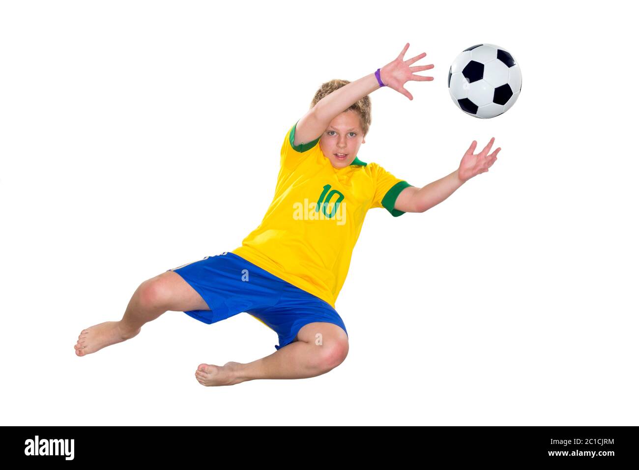 Brazilian Boy, jumping, keeper catches ball. Stock Photo