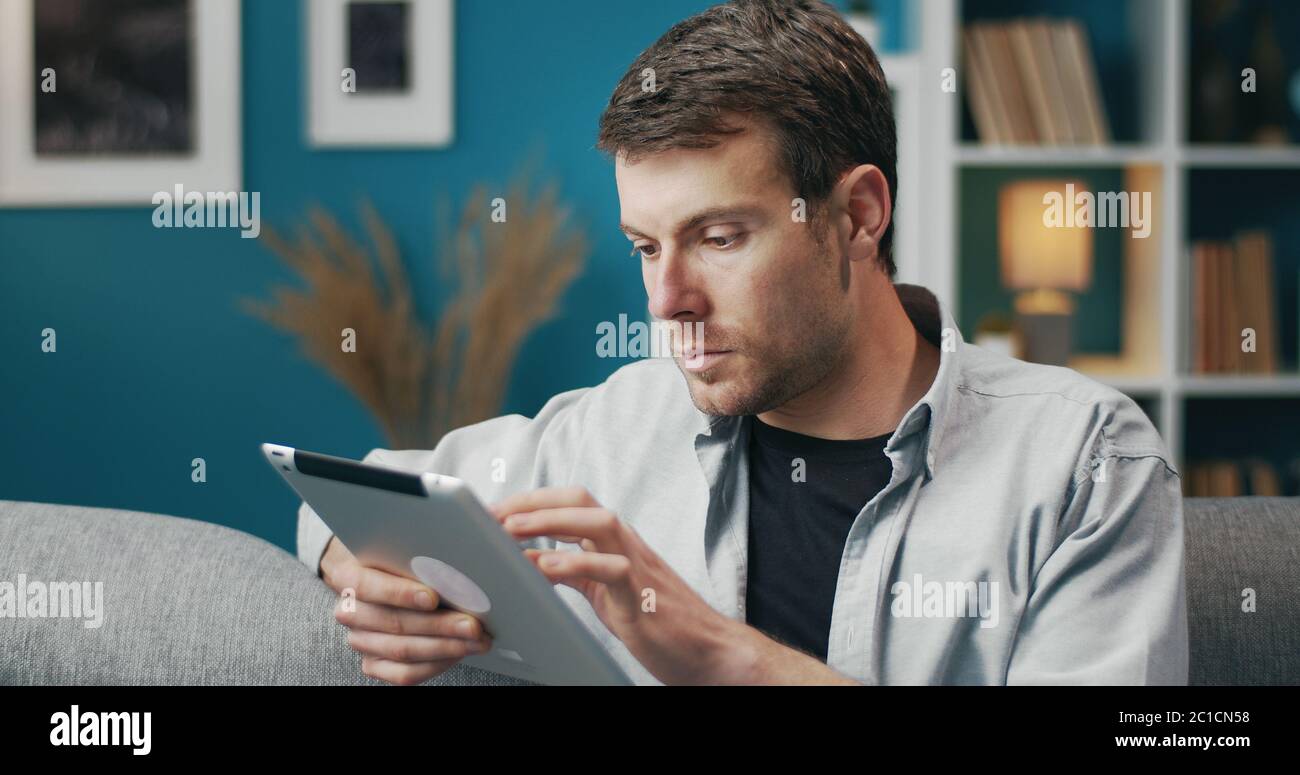 Man using tablet touching screen Stock Photo