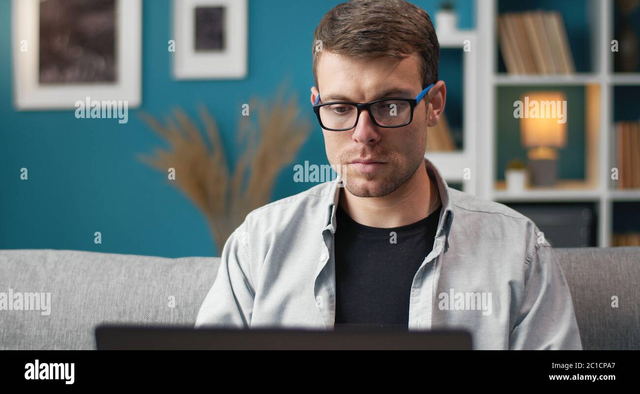 Man using laptop in flat Stock Photo