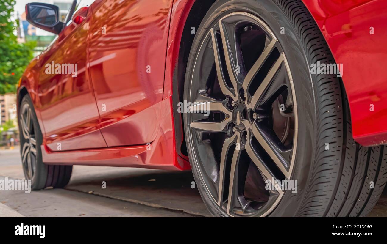 Panorama Shiny red car exterior with close up of the black rubber