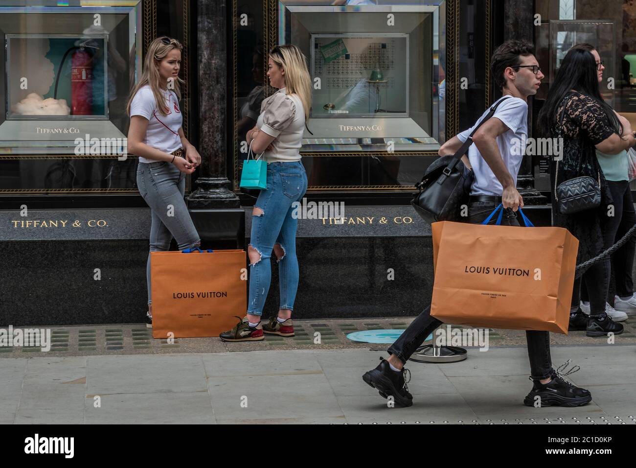 London, UK. 12th Apr, 2021. Shoppers queue outside Louis Vuitton in New  Bond Street. Number of shoppers in central London booms as Covid19  restrictions are eased. Credit: SOPA Images Limited/Alamy Live News