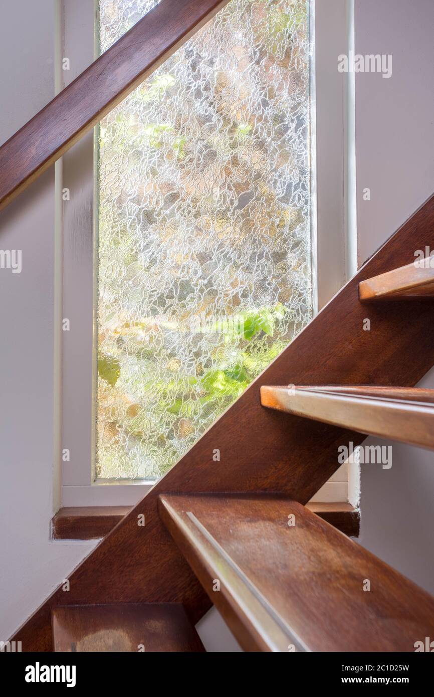 modern brown staircase with wooden floor and glass barrier Stock Photo