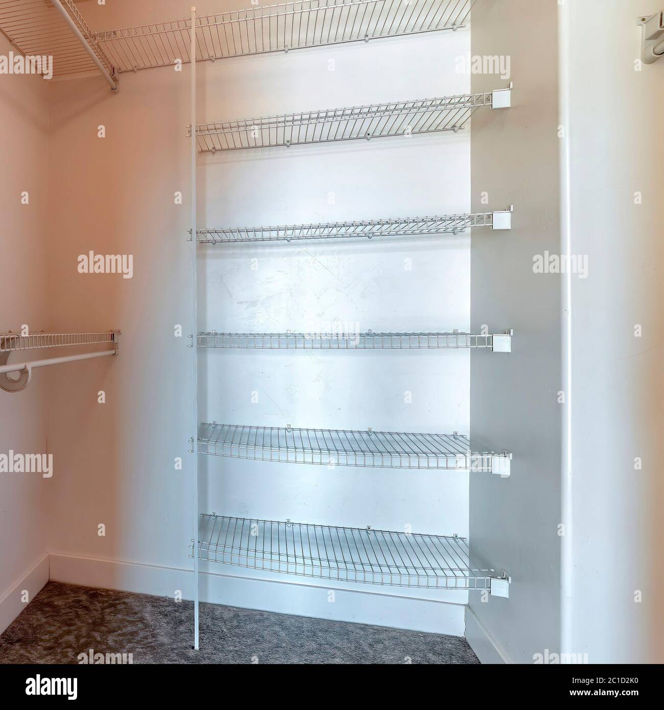 Square crop Walk in closet with metal racks and hanging rods mounted on ...