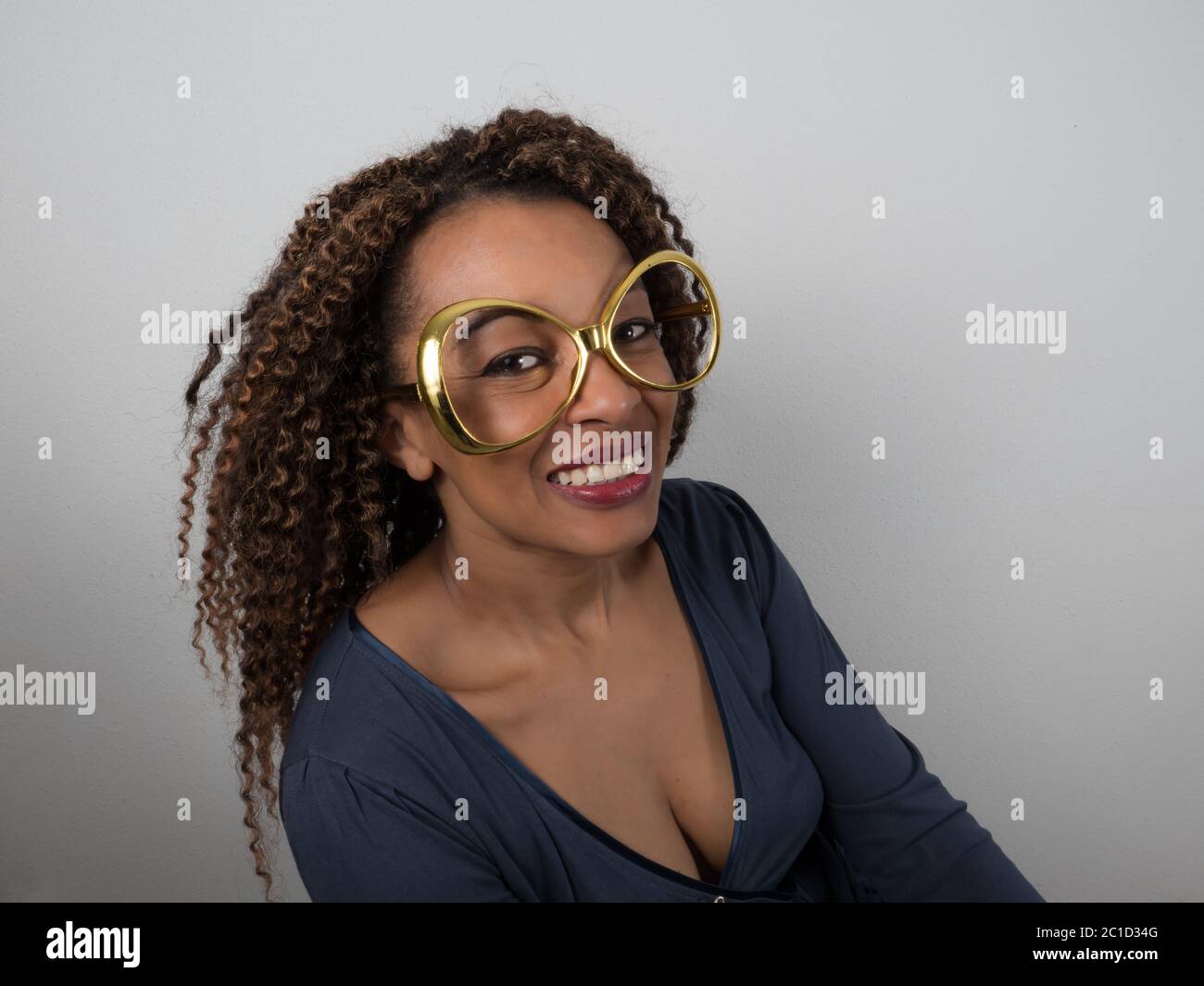 Horizontal portrait of a joyful Afro American woman wearing funny eyeglasses Stock Photo