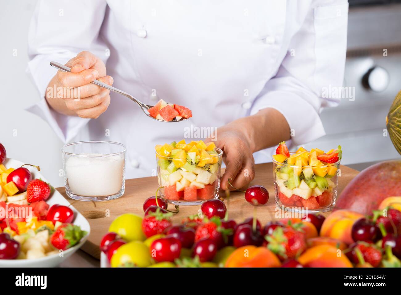 Chef preparing a delicious salad of mixed fruits Stock Photo