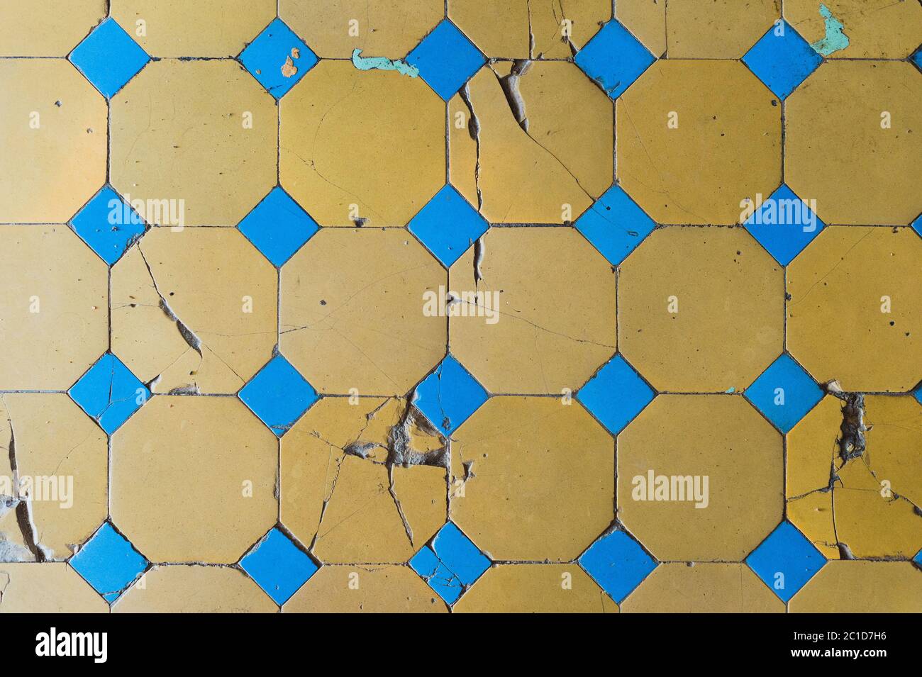Close-up of an old floor tile with a two-tone pattern. Chapped floor tiles Stock Photo