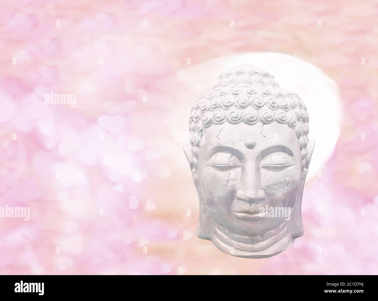 Sleeping Buddha head on pastel pink yellow hearts Stock Photo