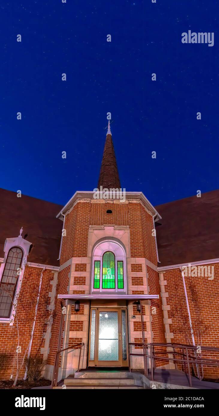 Vertical Brick church in Provo Utah with arched window and glass door at the entrance Stock