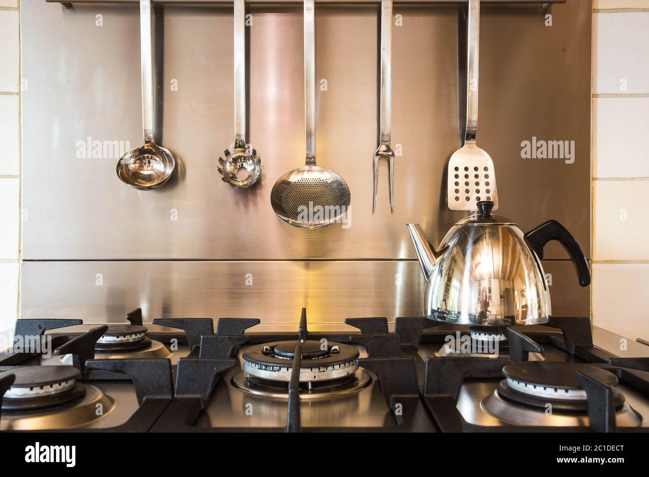 A stainless steel pan full of boiling water on a gas hob in a modern