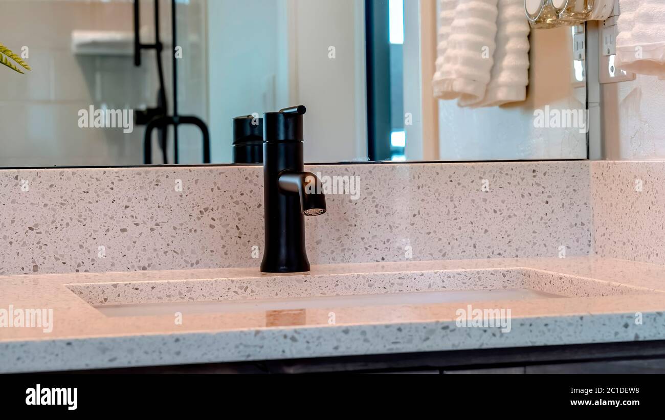 Panorama frame Undermount sink with black faucet on white countertop
