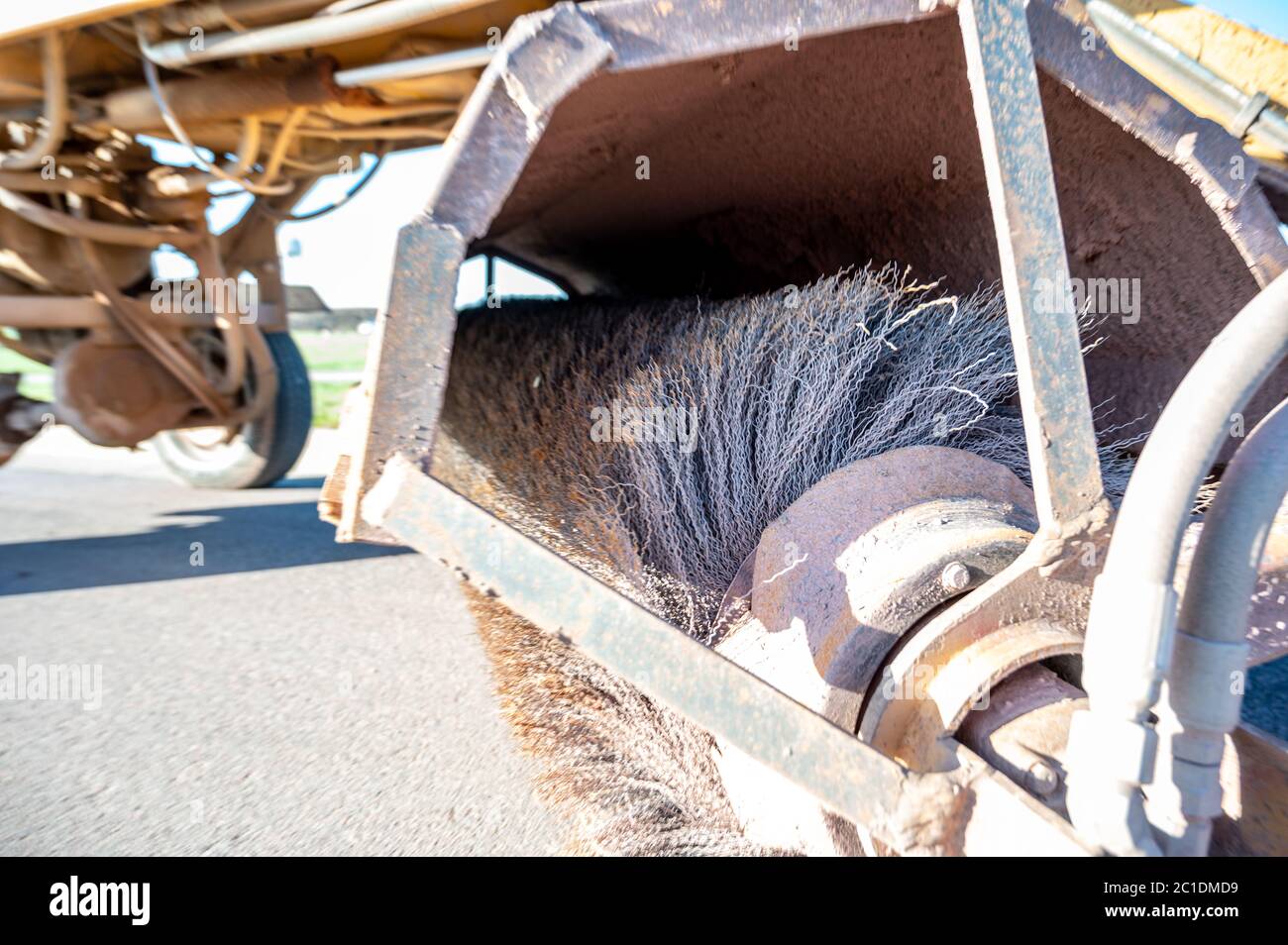 Street sweeper used in construction cleanup activity to remove dirts from paved surfaces Stock Photo