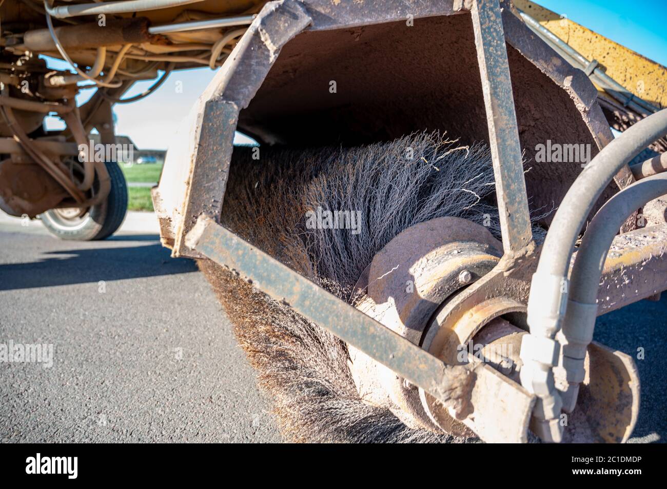 Street sweeper used in construction cleanup activity to remove dirts from paved surfaces Stock Photo