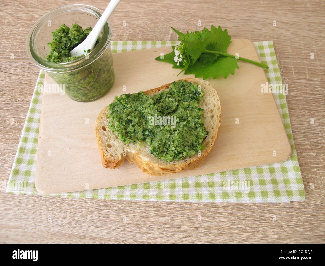 Homemade garlic mustard pesto on baguette Stock Photo