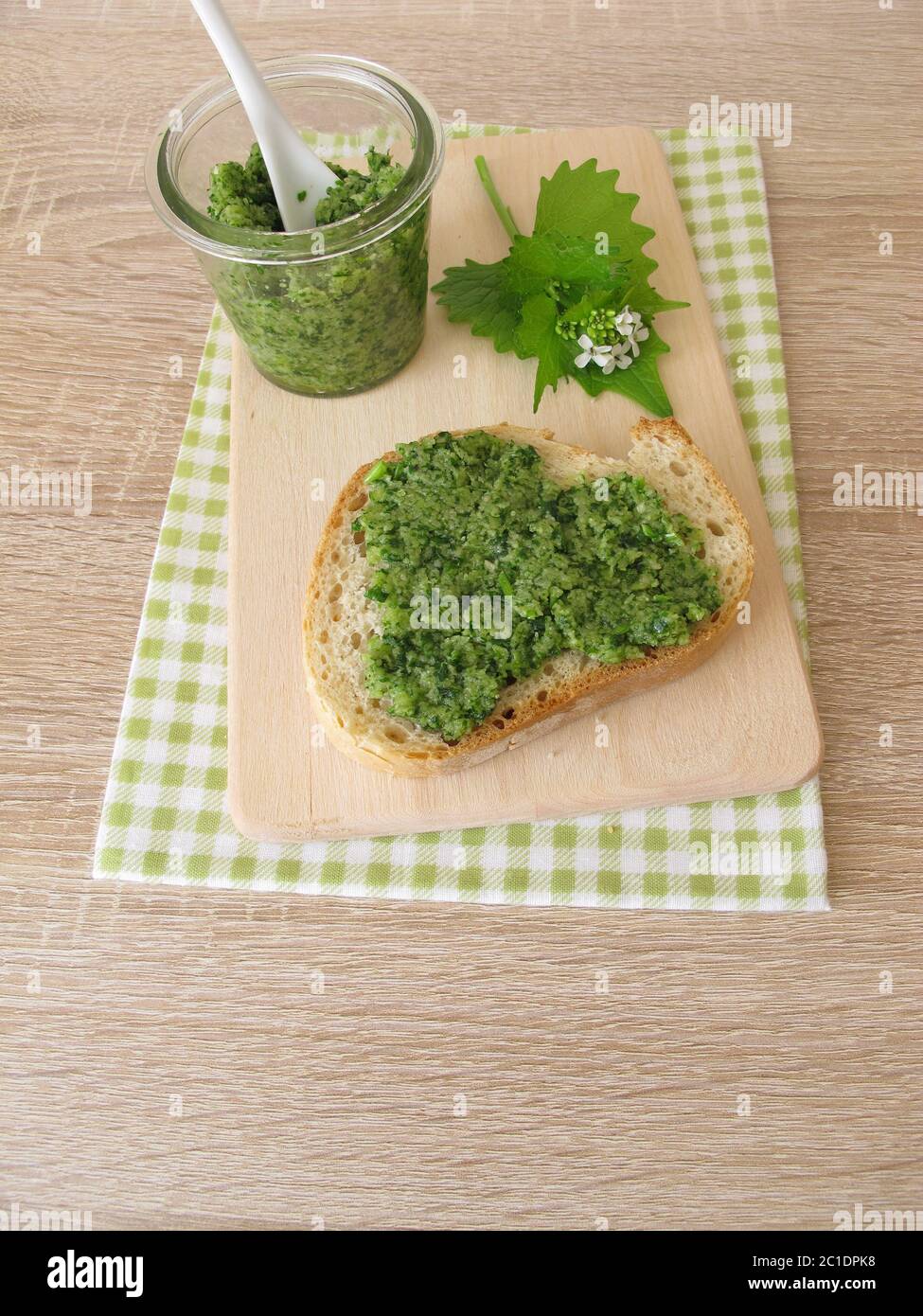 Homemade garlic mustard pesto on baguette Stock Photo