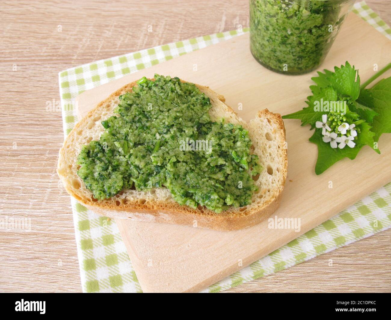 Homemade garlic mustard pesto on baguette Stock Photo
