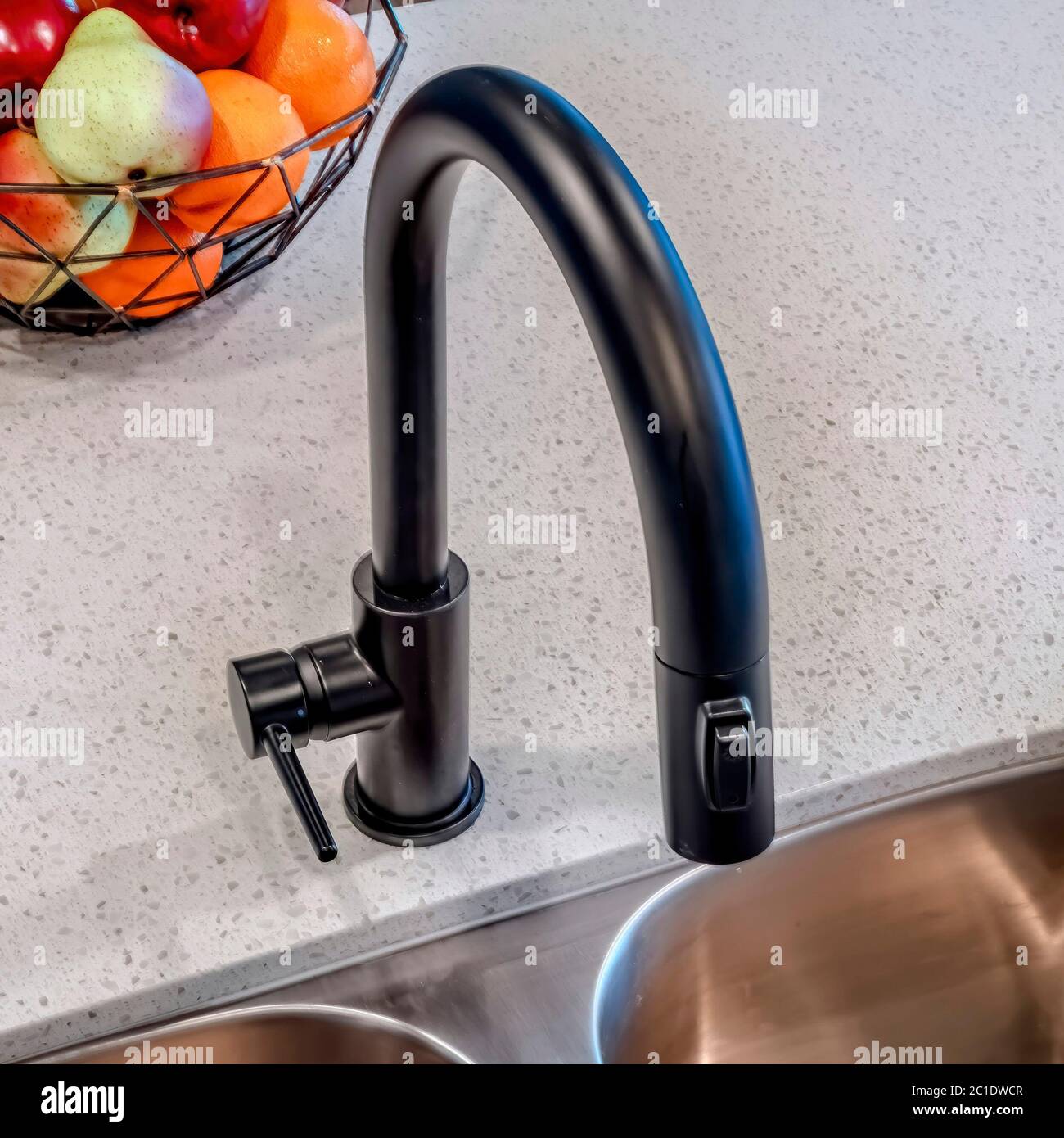 Square Curved gooseneck shaped black faucet over kitchen island sink