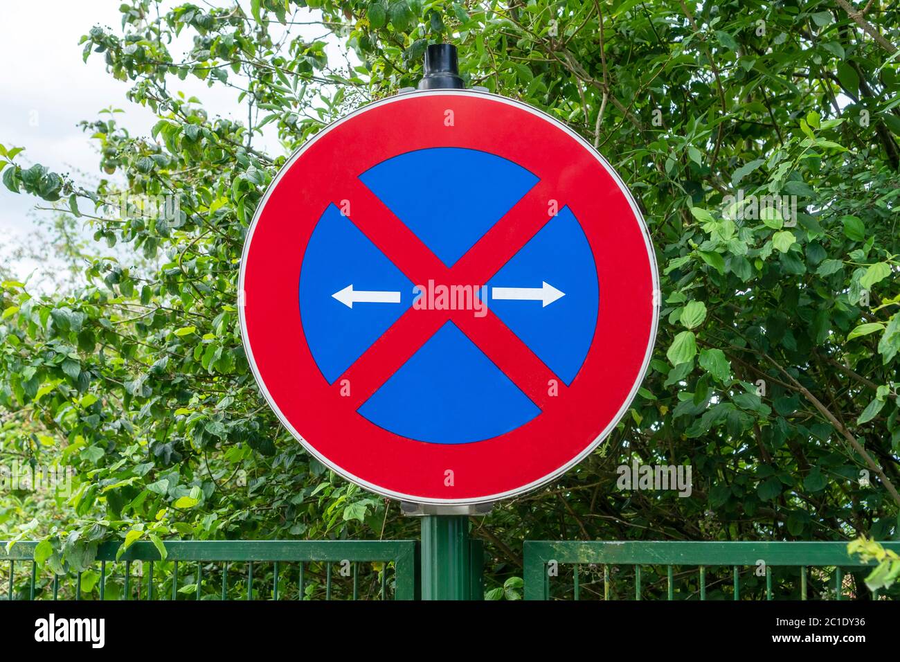 Meaning and importance of road sign blue background red cross in