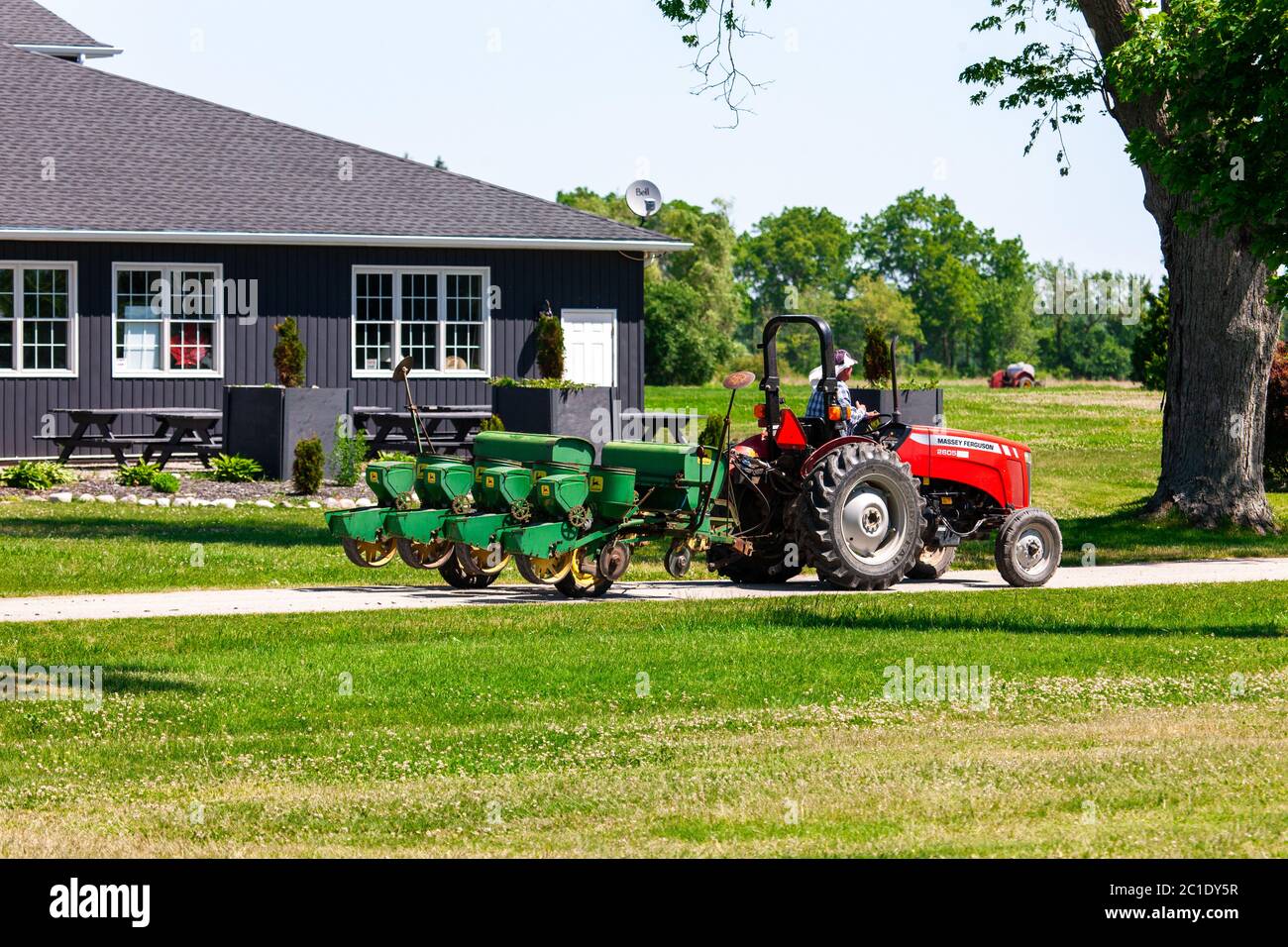 Talbotville, Canada - June 15, 2020. June in Southwestern Ontario means the start of Strawberry season. A farmer drives his tractor back to the barn after planting seed. Mark Spowart/Alamy Live News Stock Photo