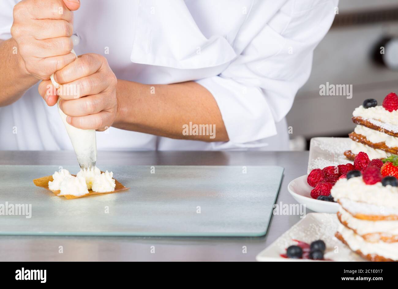 Cream filling pastry chef on a puff pastry Stock Photo - Alamy