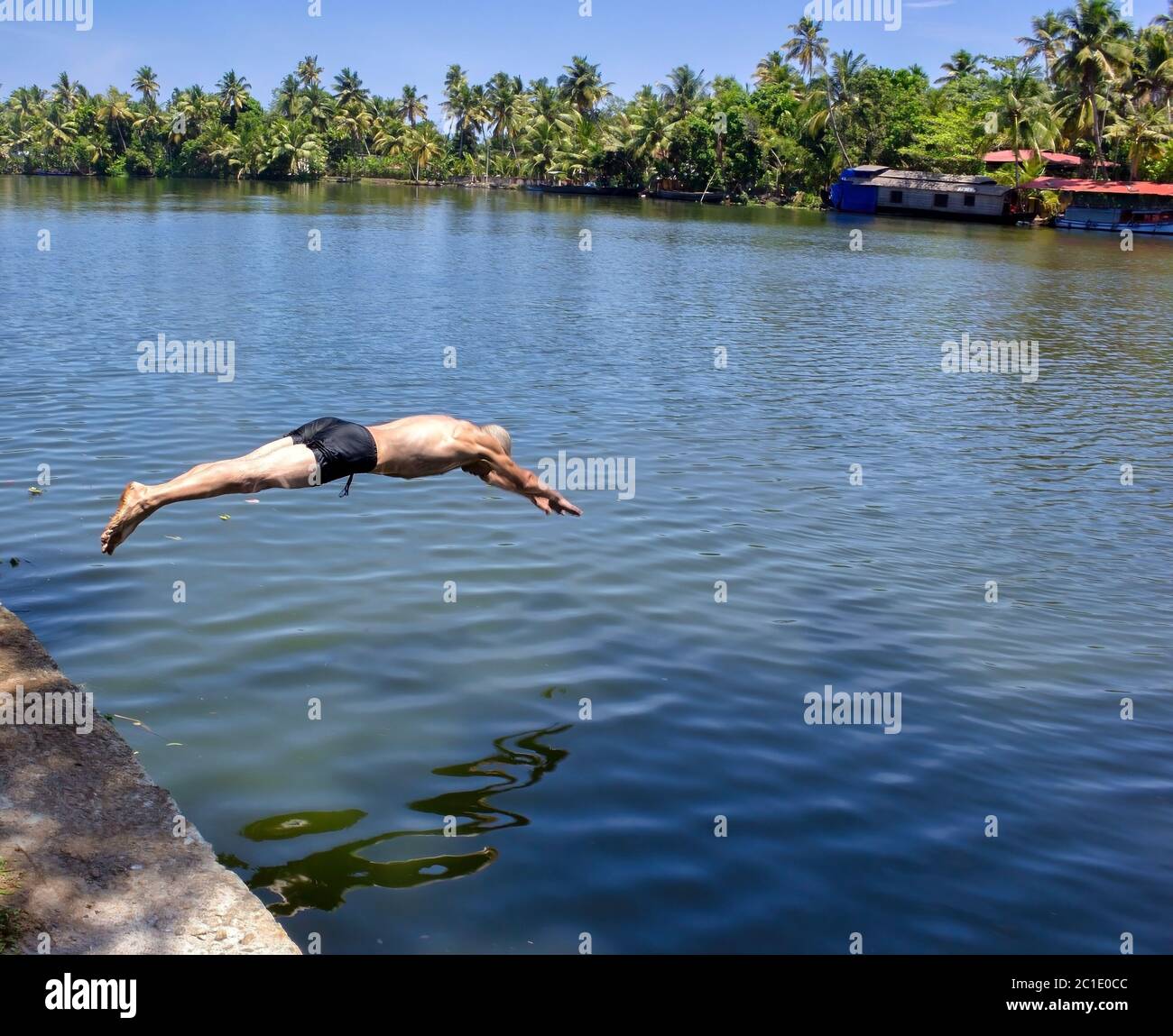 A french man dive in shorts in the backwater of Allepey Stock Photo Alamy