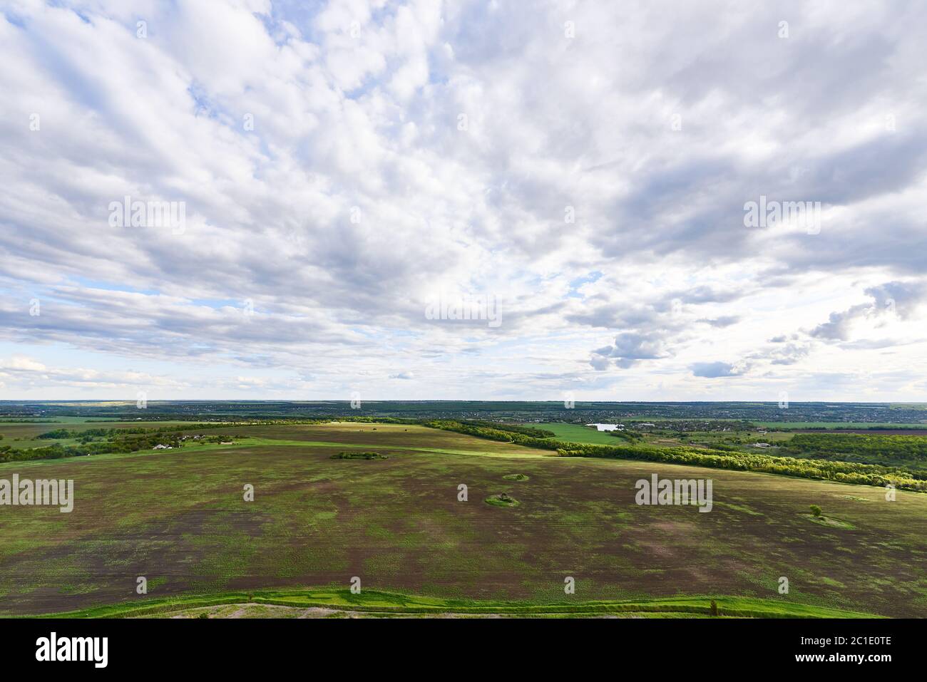 Aerial view of green fields under a blue sky with clouds Stock Photo ...