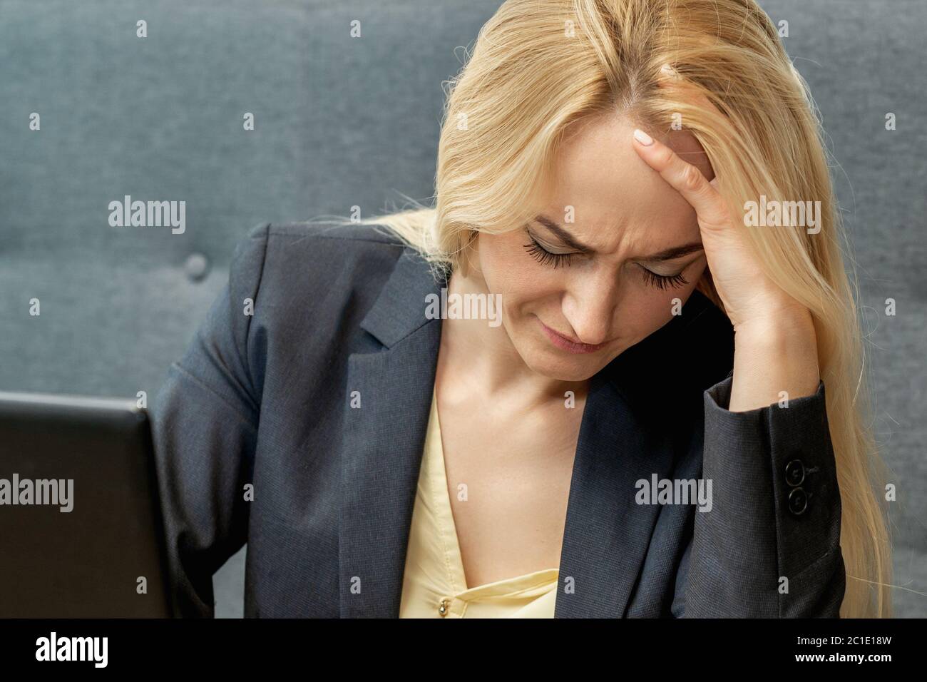 Woman looking surprised while using smartphone at the workplace at home. Stock Photo