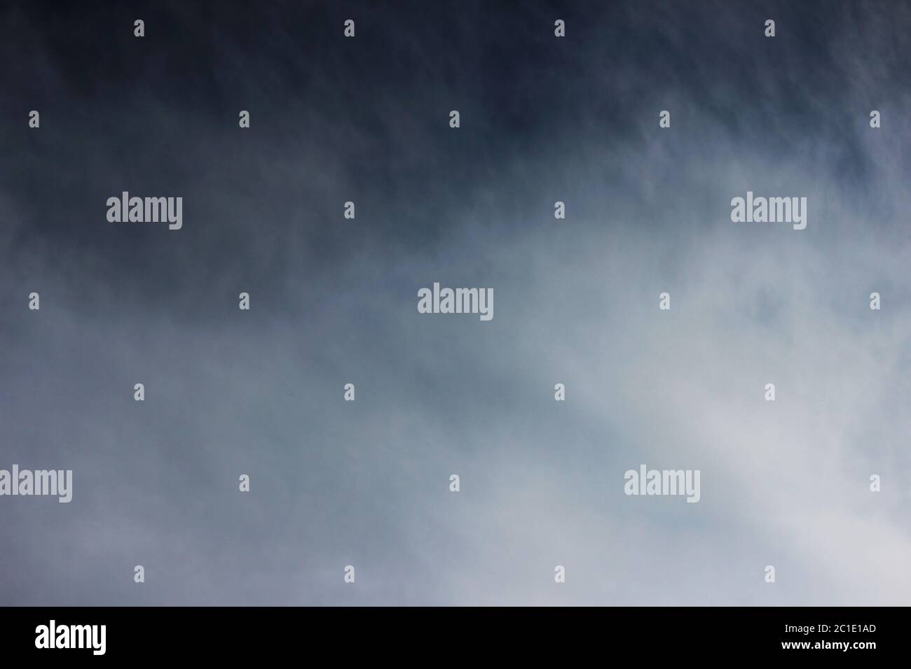 A stormy summer cloud of dark blue color carries a heavy downpour. Stock Photo
