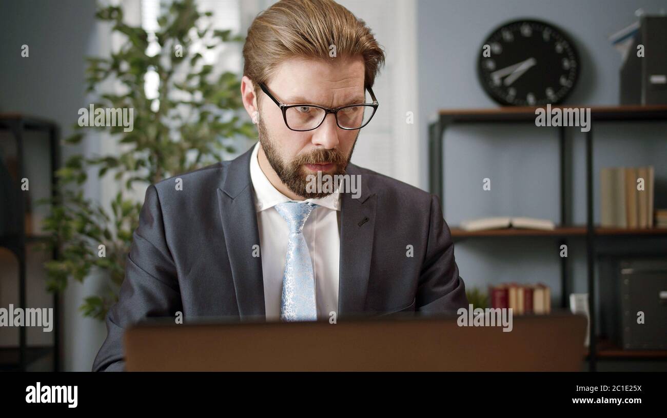 Serious businessman working on laptop Stock Photo