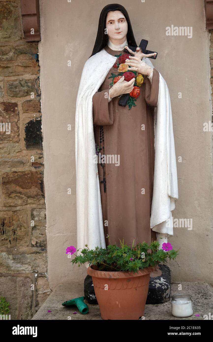 A statue of St Therese of Lisieux in the grounds of The Catholic Church