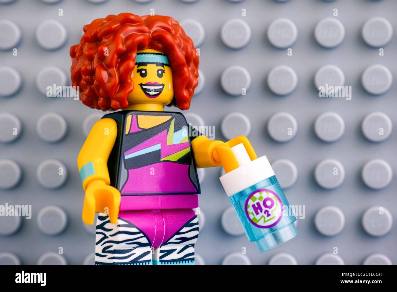 Tambov, Russian Federation - June 04, 2020 Portrait of Lego Dance Instructor minifigure with water bottle against gray baseplate background. Studio sh Stock Photo
