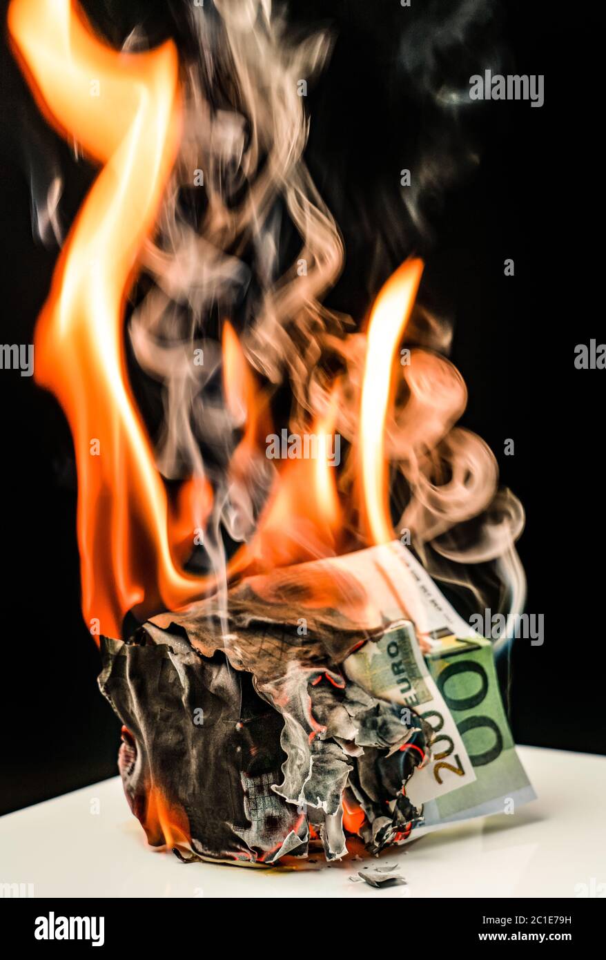 eur banknotes are burning against black background Stock Photo