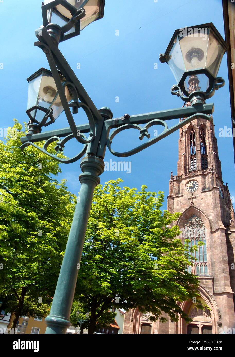 Neogothic church tower with antique street lamp in the foreground 2 Stock Photo