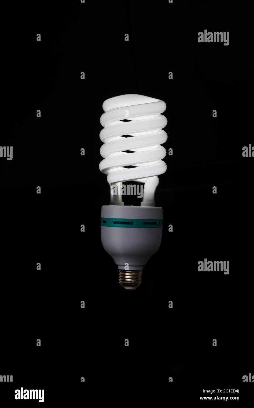 Illuminated light bulb on black background Stock Photo Alamy