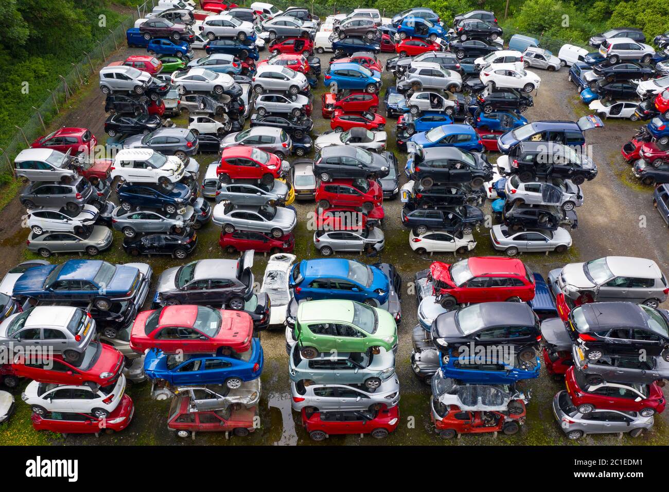 Aerial view of many cars stored in a car breaking yard or scrap yard in Scotland, UK. Stock Photo