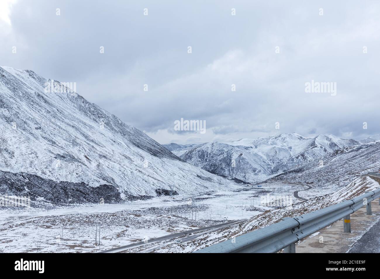 Empty road through snow mountains hi-res stock photography and images ...