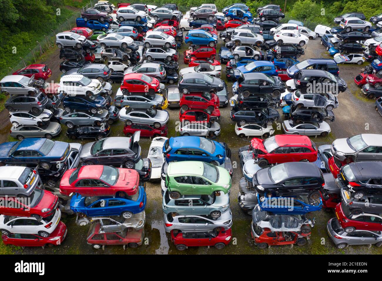 Aerial view of many cars stored in a car breaking yard or scrap yard in