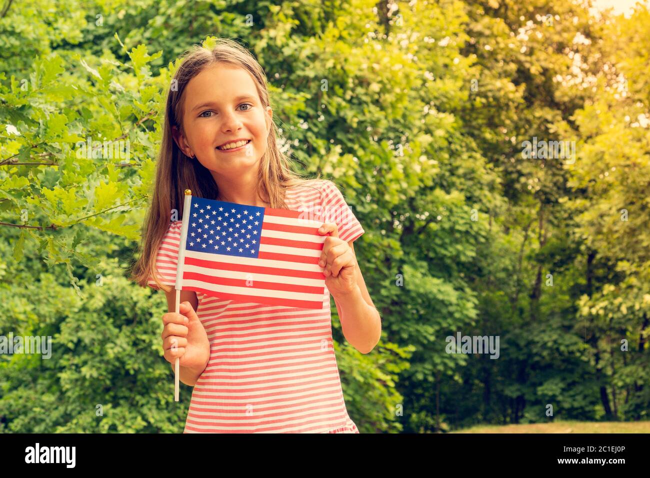 Young girl holding an American Flag Stock Photo - Alamy