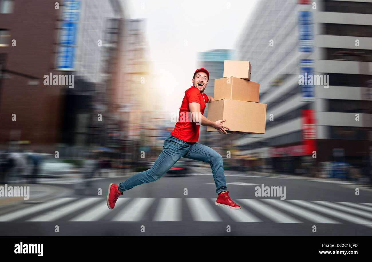 Courier has a lot of boxes to delivery. Emotional expression. Stock Photo