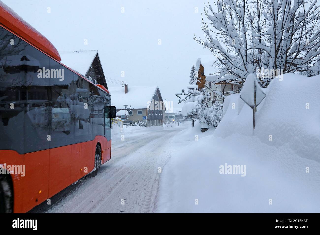 Delays in public transport due to heavy snowfall. A bus has difficulties on the snow-covered road in winter. Stock Photo