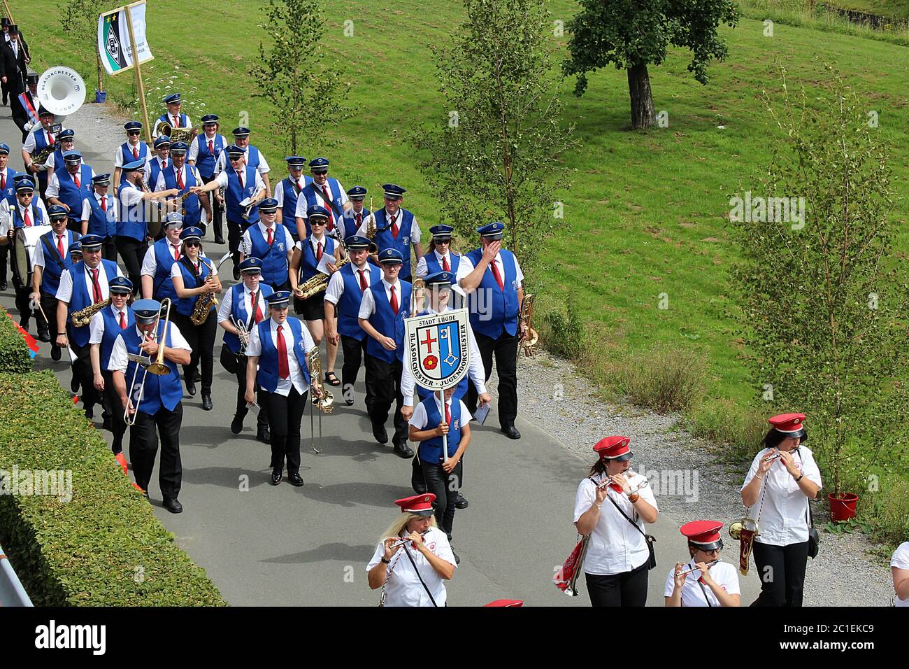 Festive procession of a marching band through residential area at a traditional German Schützenfest (marksmen's festival) in Lügde. Stock Photo