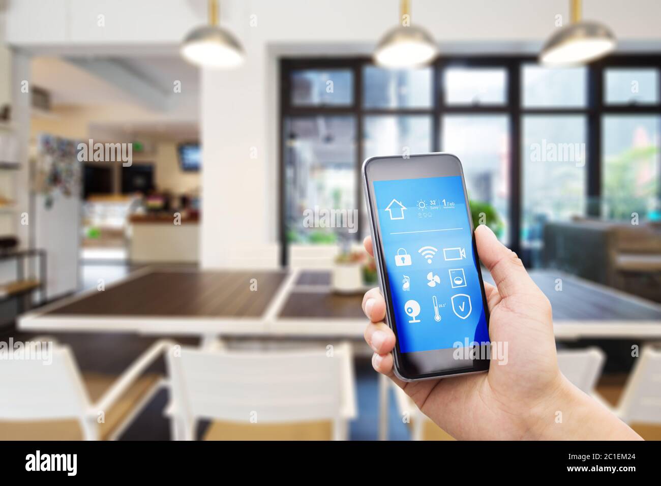 mobile phone with smart home app in modern living room Stock Photo - Alamy