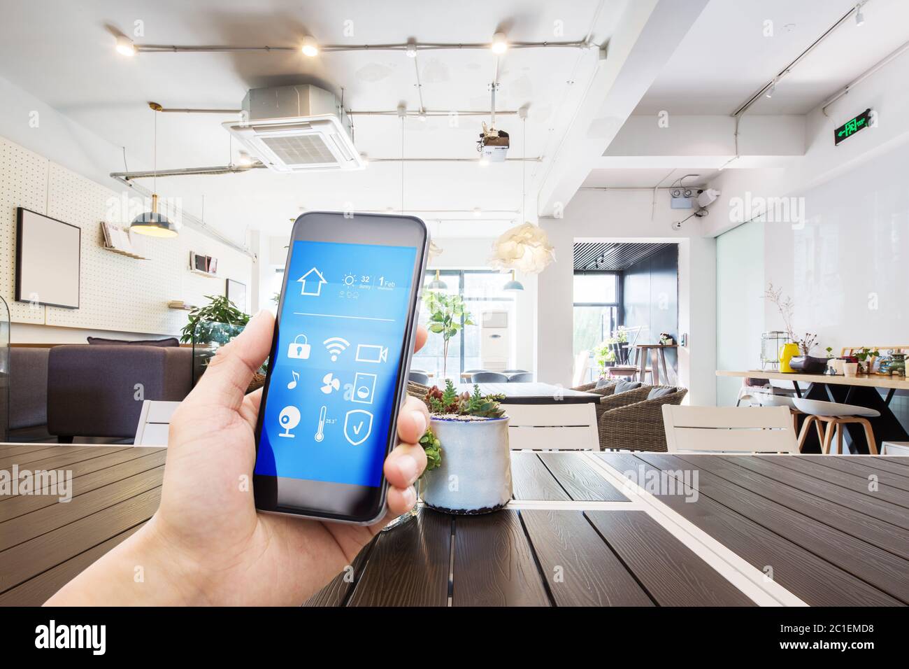 mobile phone with smart home app in modern living room Stock Photo - Alamy