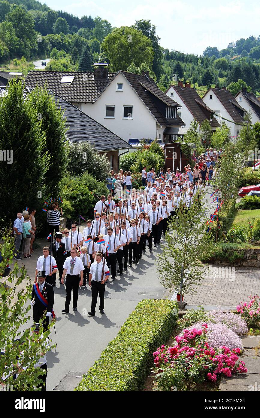 Festive procession of the associations of marksmen through residential area at a traditional German Schützenfest (marksmen's festival) in Lügde. Stock Photo