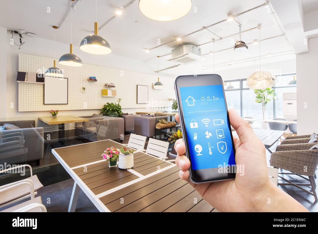 mobile phone with smart home app in modern living room Stock Photo - Alamy