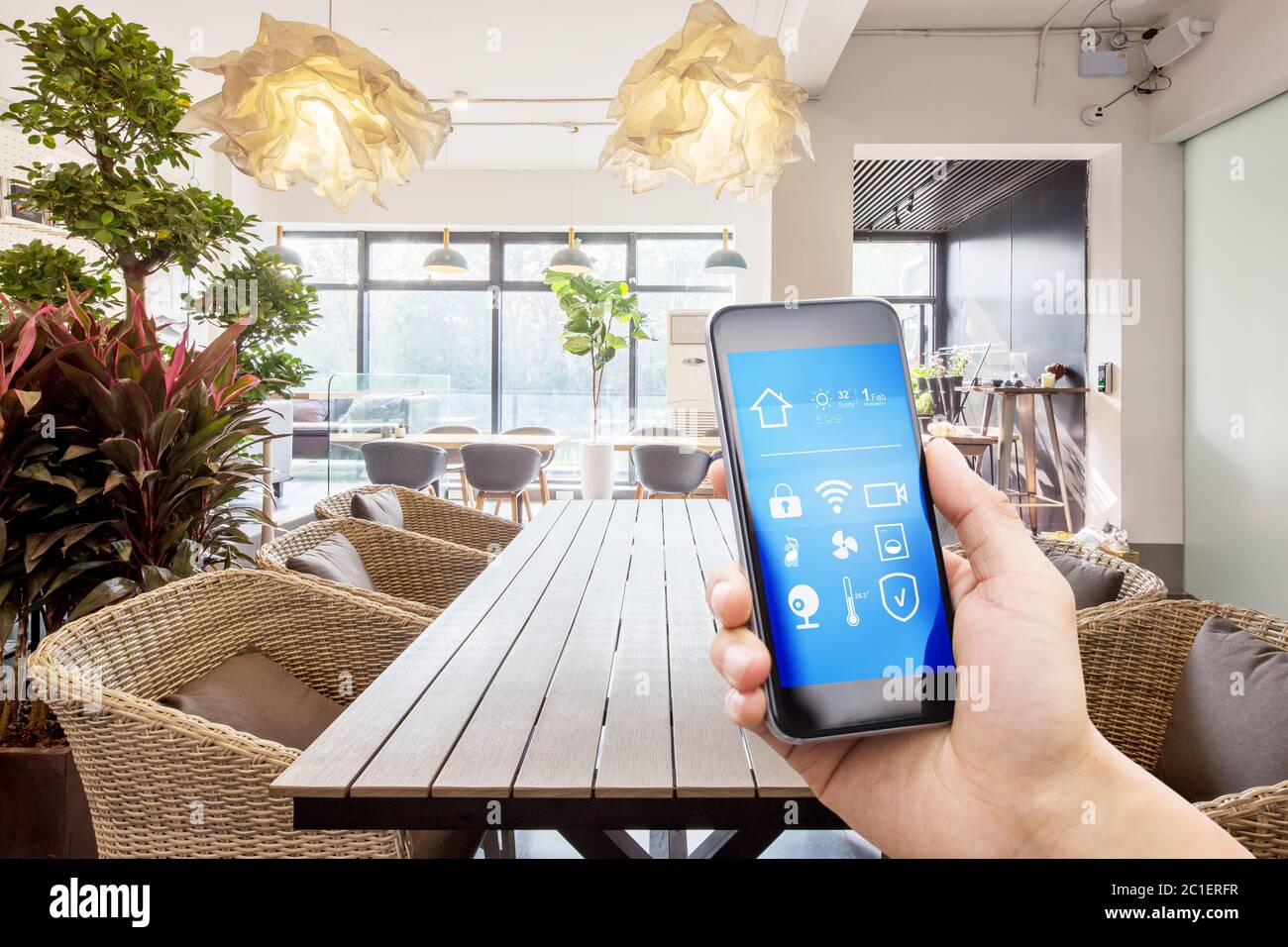 mobile phone with smart home app in modern living room Stock Photo - Alamy