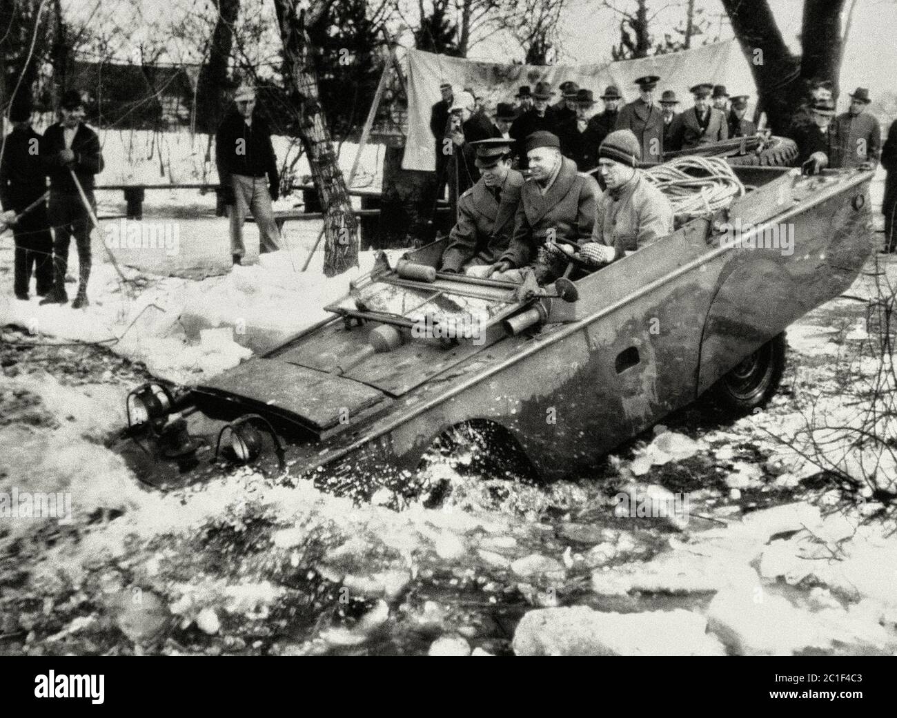 1943, March 23. One of new product - an amphibious jeep produced for the US army, slides into icy water for testing, in the Detroit area Stock Photo