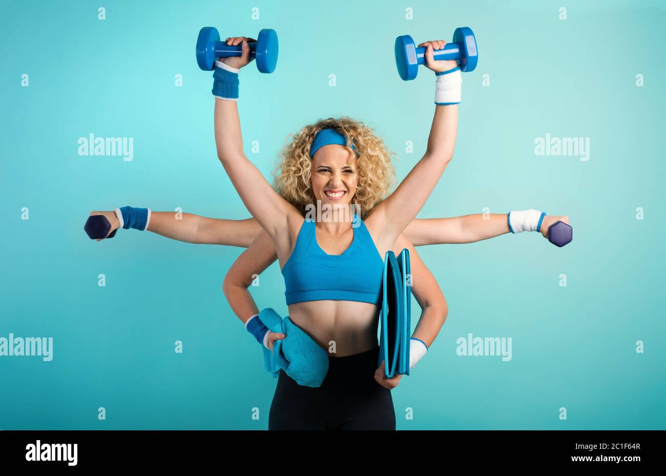 Multitasking girl at the gym. Concept of fatigue and stress. Cyan background Stock Photo