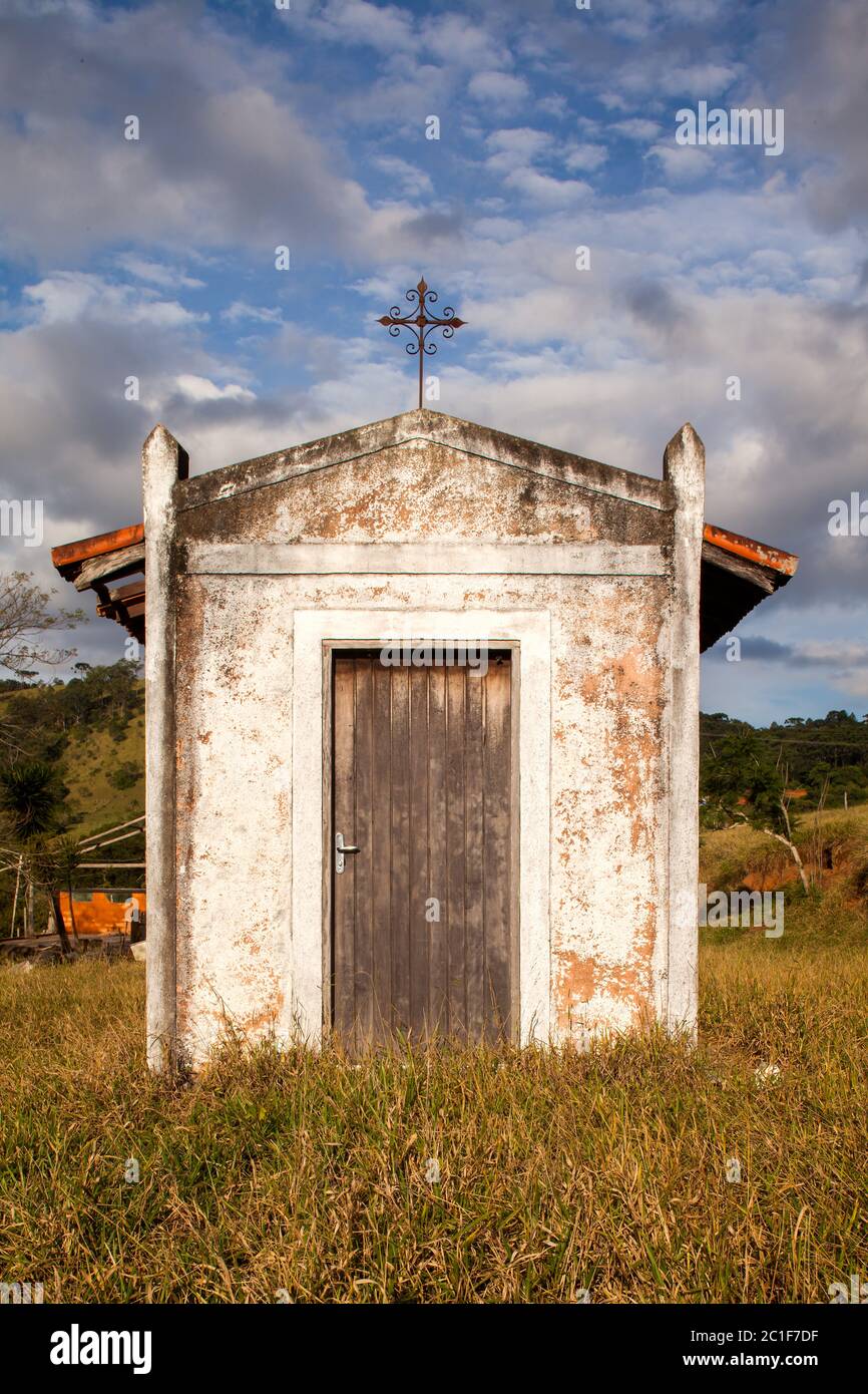 Small old white church in the countryside in a blue sky day Stock Photo